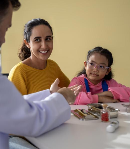 Male doctor and girl young patient Talk and give advice about your illness at the hospital.